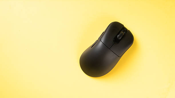 istock A black ergonomic wireless mouse placed on a bright yellow background, showcasing a clean, modern workspace accessory ideal for tech setups or office-themed visuals 2223188942