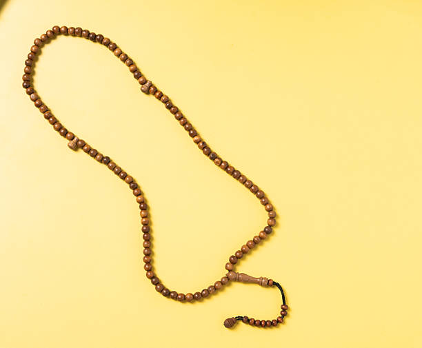 istock A wooden prayer bead string (tasbih) arranged on a bright yellow background. A spiritual accessory often used for meditation, prayer, and mindfulness in Islamic practices 2223189096