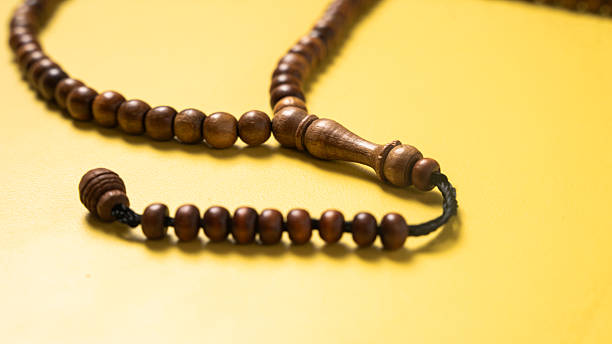 istock A wooden prayer bead string (tasbih) arranged on a bright yellow background. A spiritual accessory often used for meditation, prayer, and mindfulness in Islamic practices 2223189239