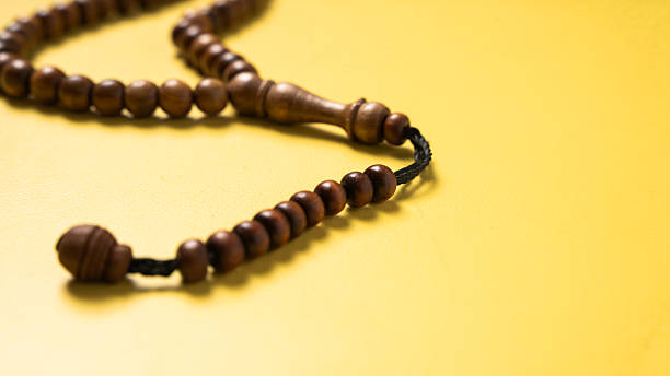 istock A wooden prayer bead string (tasbih) arranged on a bright yellow background. A spiritual accessory often used for meditation, prayer, and mindfulness in Islamic practices 2223189358
