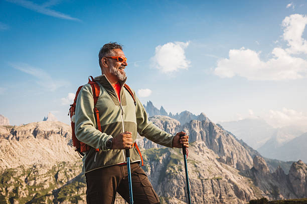 Mature man with backpack hiking at Dolomite
