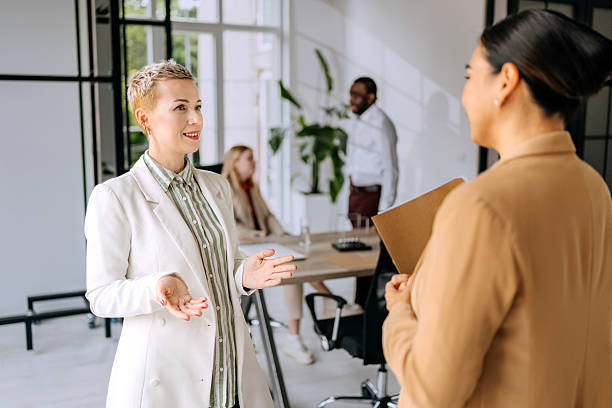 istock Two businesswomen engaged in a discussion at a modern office 2223190623