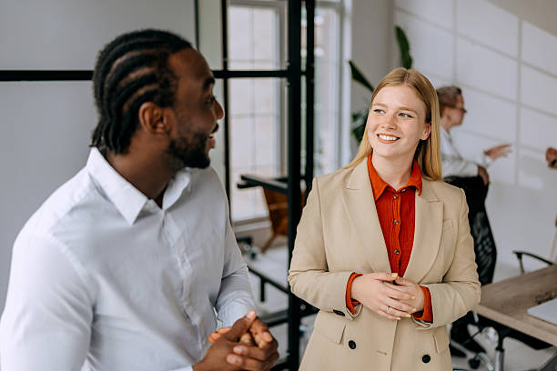 istock Two young colleagues walking and talking at modern office 2223190653