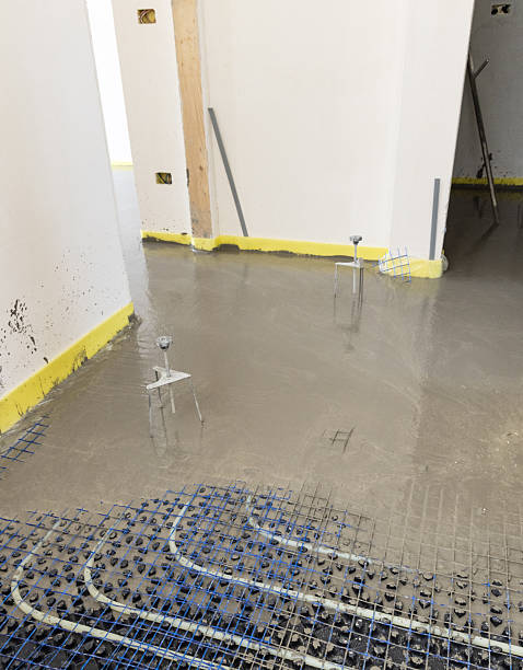 istock Liquid concrete is poured over floor heating installation in a new building. Modern construction system 2223190797