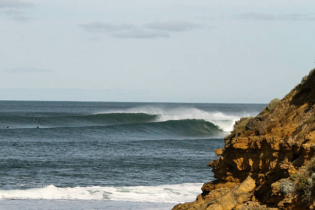 istock Surfers Catching Clean Waves off Rocky Australian Coast 2223191575