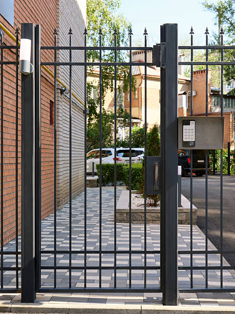 Closed courtyard of a residential building with an electronic code lock on the fence. Modern security technologies in the city.