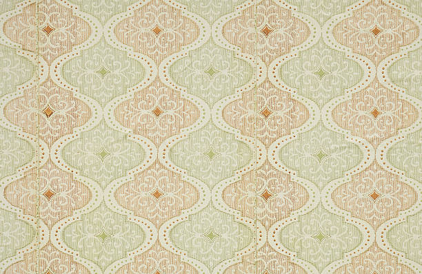 Old wallpaper on the wall. Old wallpaper for texture or background.