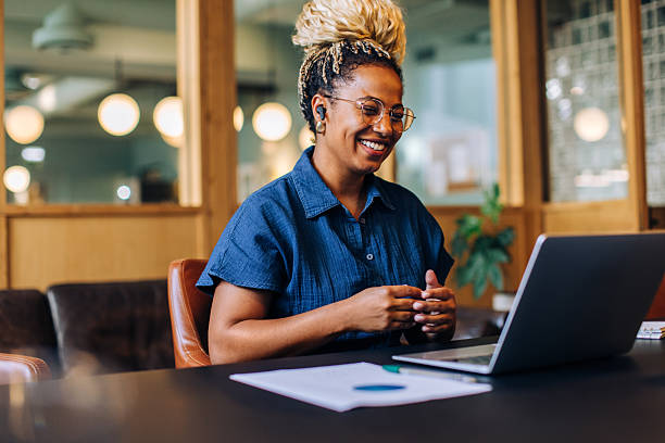 istock Smiling woman having a video call in a casual business setting 2223201247