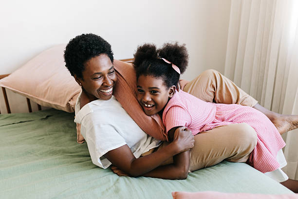 istock Mom and daughter smiling after a pillow fight 2223202078