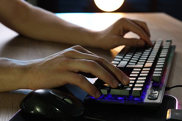 istock Young man using computer keyboard at wooden table indoors, closeup 2223203402
