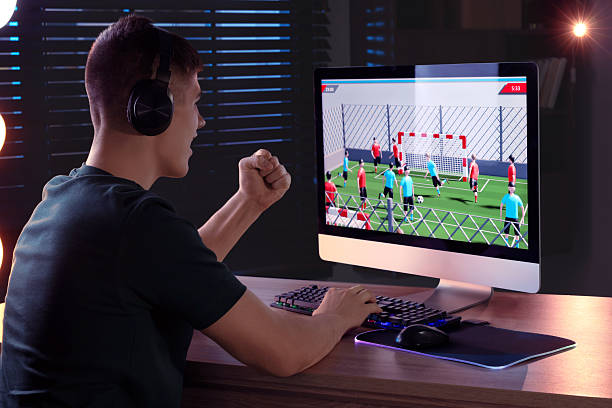 istock Young man playing video game with keyboard at wooden table indoors 2223203440