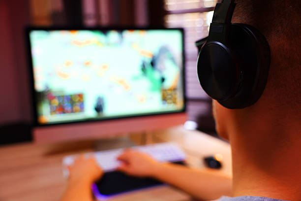 istock Young man playing video game at table indoors, closeup. Space for text 2223203566