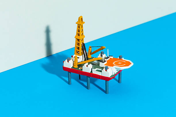 Small toy model of a drilling rig on colored background cardboard