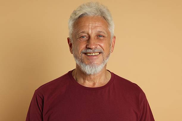 istock Portrait of senior man on beige background 2223205708