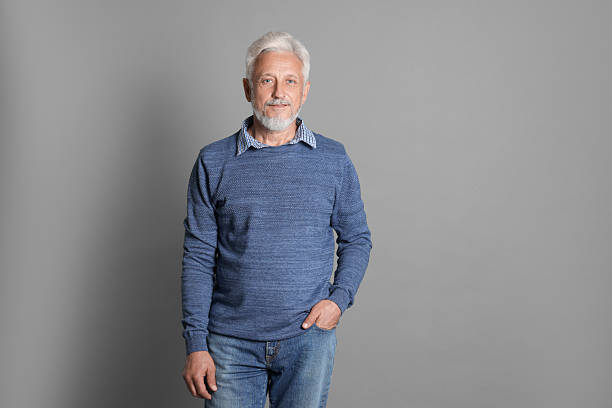 istock Portrait of senior man on grey background 2223205970