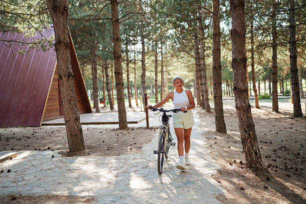 Beautiful woman in casual clothes rides a bicycle along sunny city streets. Concept of walks, vacation, travel. Active lifestyle.