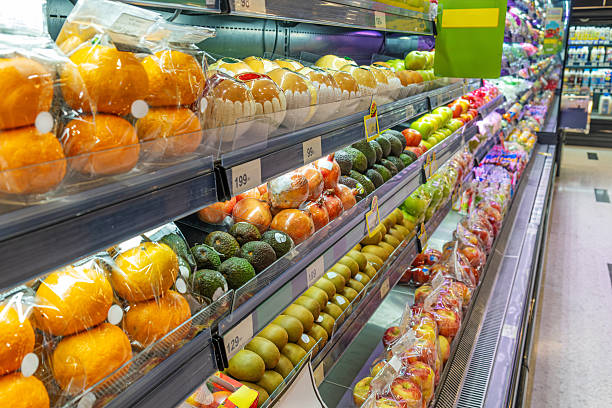 istock Supermarket fruit refrigerated section with rows of packaged fresh fruits including oranges, apples, avocado and kiwi, showcase freshness, convenience and healthy eating. Food retail in grocery store 2223210087