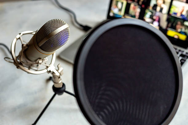 istock Podcast recording - laptop computer and microphone on the table, close up 2223212312