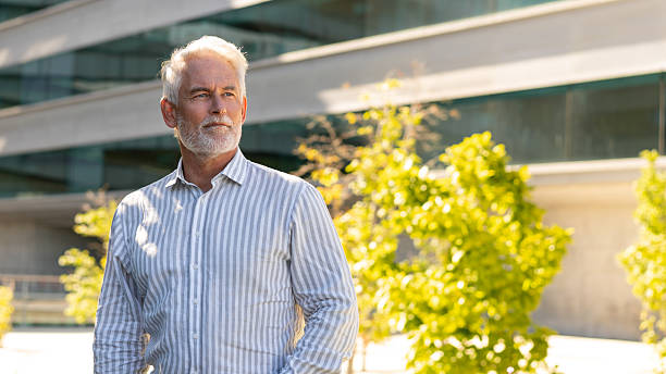 istock Senior businessman standing confidently near modern office building 2223213334