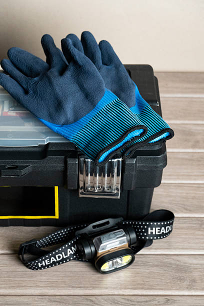 Close-up of a black toolbox containing blue gloves and a headlamp, ideal for DIY, repair, and outdoor work