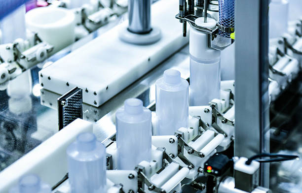 istock White plastic bottles in a conveyor belt on a high quality automatic vertical filling machine. 2223214711