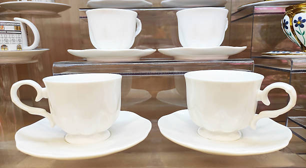istock Coffee cups and saucers with a beautiful decorative pattern on the shop window 2223216590