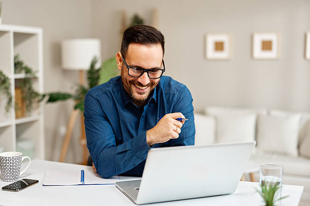 istock Happy entrepreneur working from home having a successful video call on laptop 2223216765