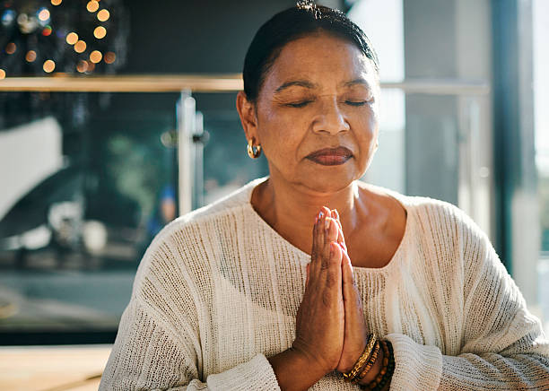 istock Calm Mature Woman Meditating in Soft Light 2223217288