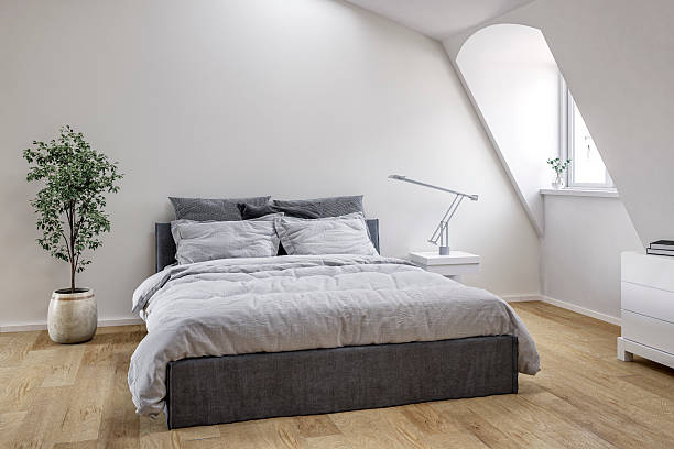 istock Modern minimalist attic bedroom with a bed, windows and decoration 2223218666