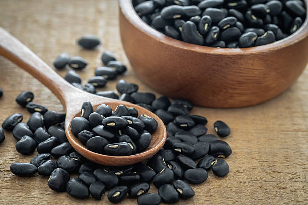istock Black bean on wooden spoon 2223218698