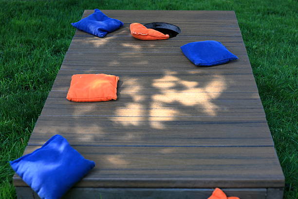 istock Blue and orange cornhole bags on a board during a backyard game 2223219164