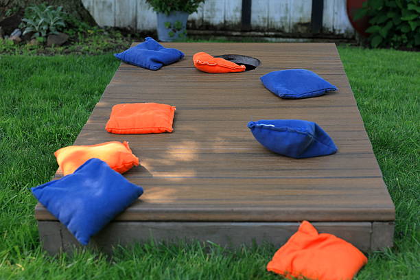 istock Blue and orange cornhole bags on a board during a backyard game 2223219173