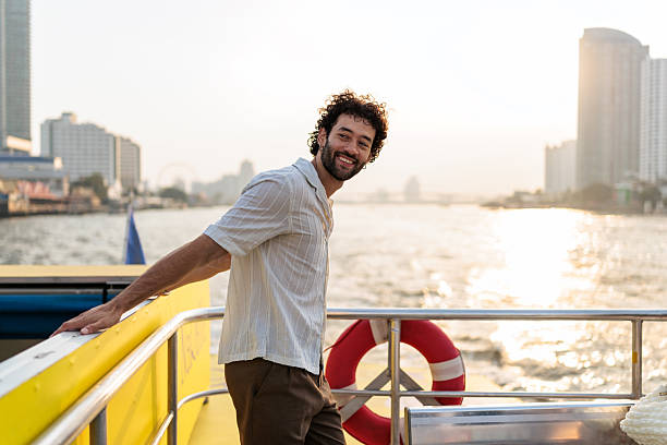 istock Man enjoying Chao Phraya river from a boat 2223220425