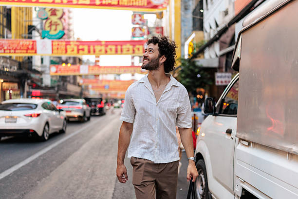 istock Smiling man exploring the streets of Bangkok 2223220858