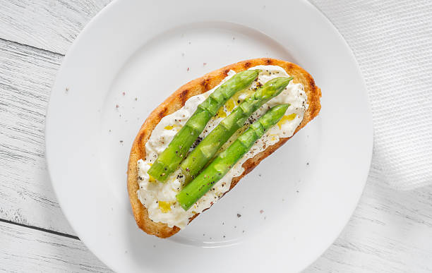 istock Grilled sandwich with white bread, stracciatella cheese, and green asparagus 2223221238