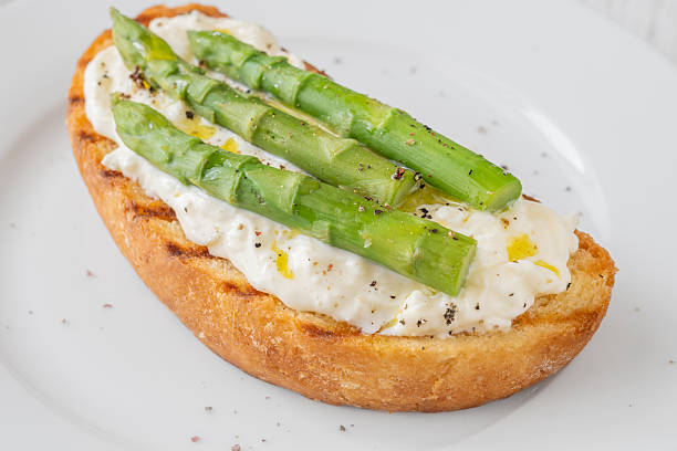 istock Grilled sandwich with white bread, stracciatella cheese, and green asparagus 2223221250