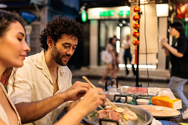 istock Couple sharing a hot pot meal together using chopsticks 2223221390