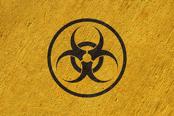 istock biohazard sign painted on concrete wall, work safety warning, black symbol on yellow background 2223222638