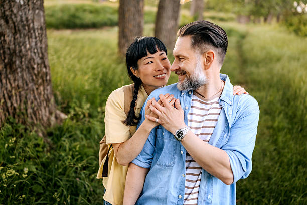 istock Casually dressed mature couple bonding in nature 2223223497