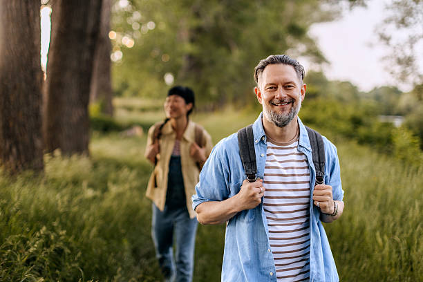 istock Smiling mature man posing for camera in nature 2223224003