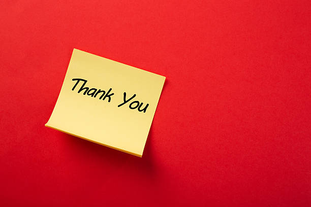istock Yellow sticky note showing thank you on red background 2223225380