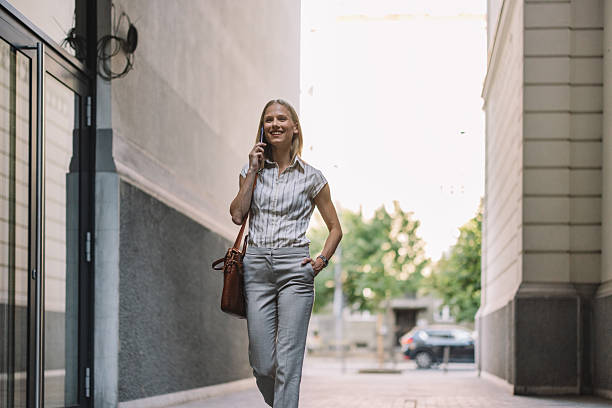 istock Happy Woman Walking on Street While Talking 2223228976