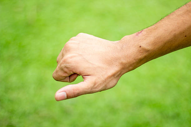 A man pointing his fingers of his hand forward and blurred background