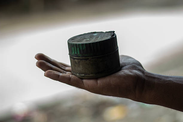 A young man is holding the old medicine box and background bur