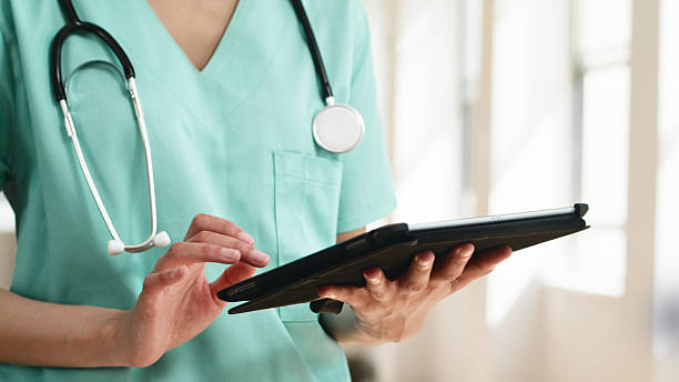 istock Healthcare Professional Using a Tablet in a Bright Medical Setting 2223230396