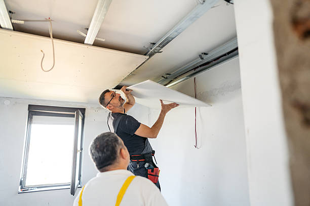 istock Two Mature Workers Installing Drywall On The Ceiling In An Empty Apartment Under Renovation 2223230416