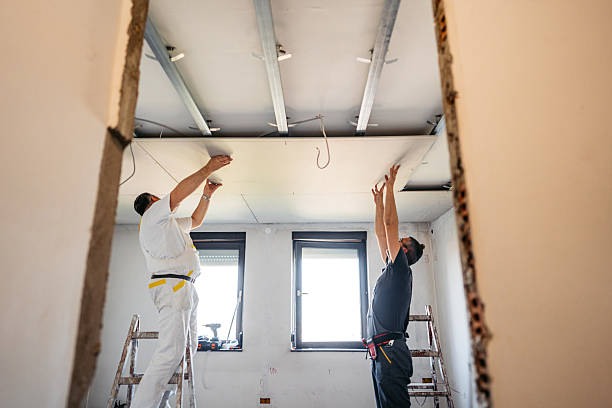 istock Two Mature Workers Installing Drywall On The Ceiling In An Empty Apartment Under Renovation 2223230467