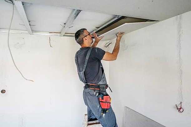 istock Mature Worker Installing Drywall On The Ceiling In An Empty Apartment Under Renovation 2223230532