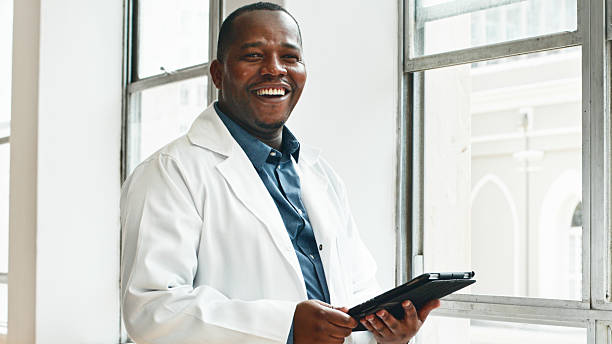 istock Smiling Medical Professional Holding a Tablet in a Bright Clinic Setting 2223231113