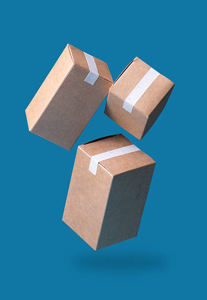 Closed and taped cardboard parcel boxes falling on blue background, Ideal for Shipping, Delivery